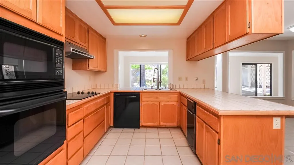14662 Silverset Street Poway, CA 92064 - Photo 8 of 25 a kitchen with stainless steel appliances granite countertop a stove a sink and a microwave