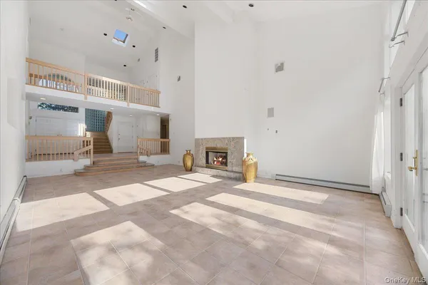 a view of a livingroom with wooden floor and a fireplace