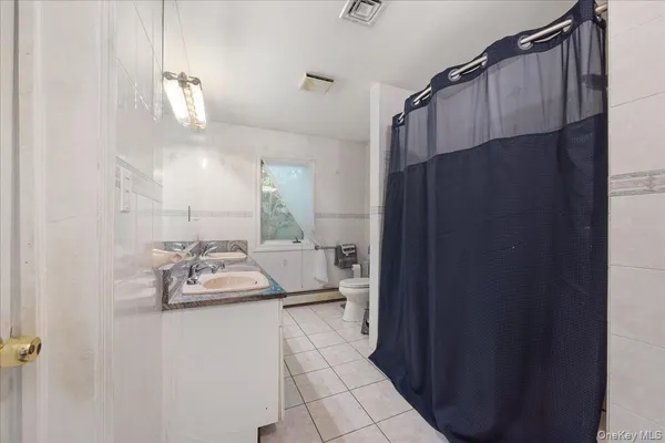 a bathroom with a sink a mirror and shower