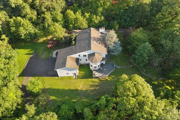 an aerial view of a house with swimming pool and garden