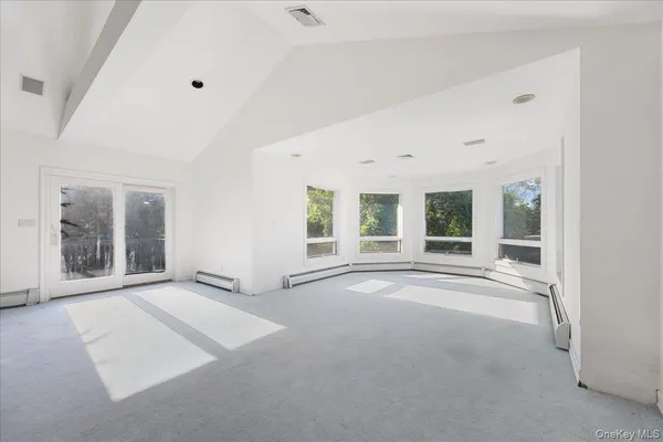 a bathroom with a granite countertop bathtub sink vanity mirror and toilet
