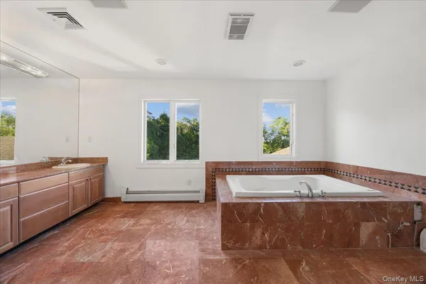 a bathroom with a bathtub and toilet