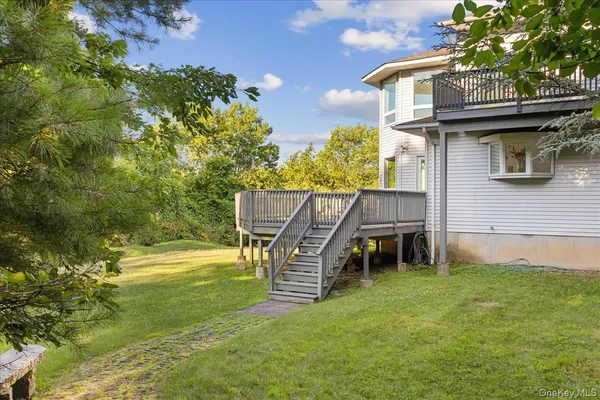 a backyard of a house with table and chairs