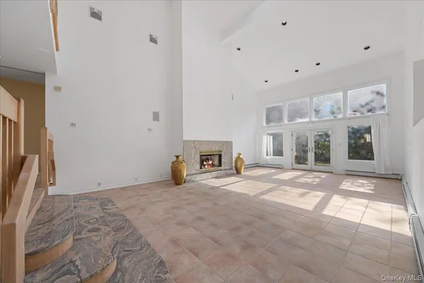 a view of empty room with a fireplace