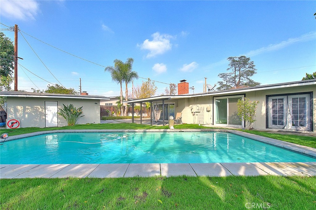 a backyard of a house with table and chairs