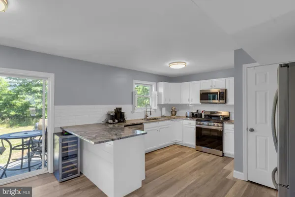 a kitchen with a stove a sink and a refrigerator