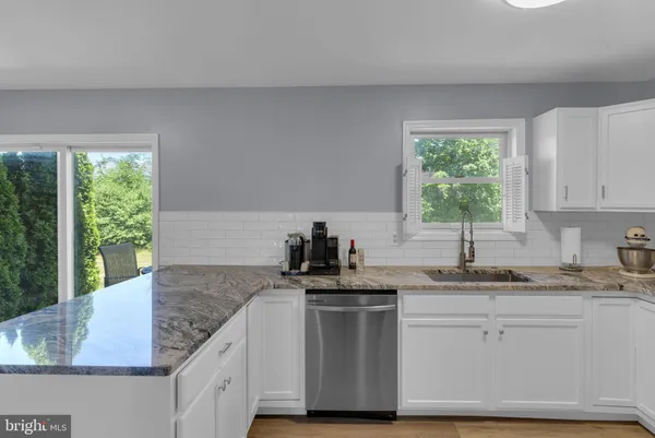 a kitchen with granite countertop white cabinets and a granite counter tops