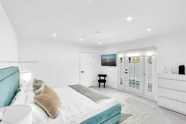 a bedroom with a bed and a television