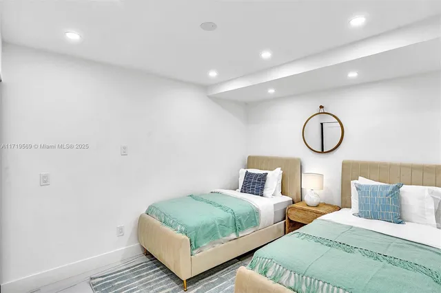 a bedroom with furniture and a flat screen tv