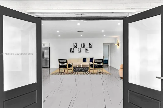 a view of living room with furniture and wooden floor