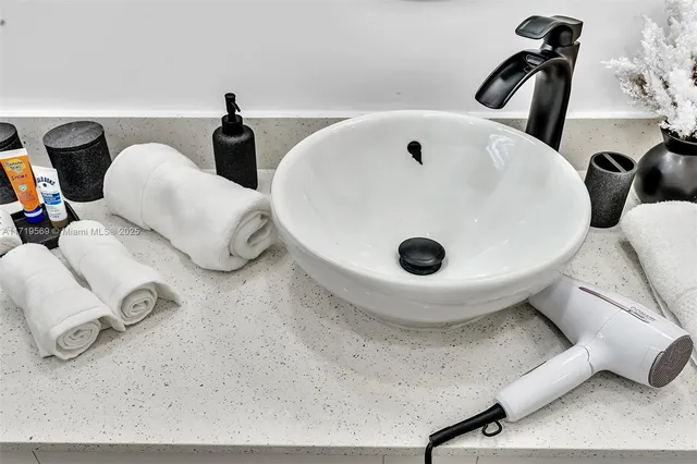 a bathroom with a granite countertop sink a toilet a mirror and shower