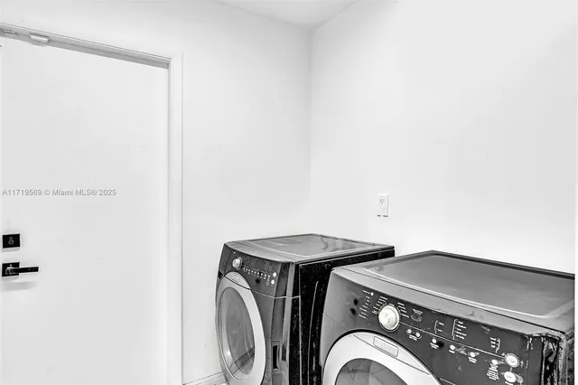 a living room with large window and furniture