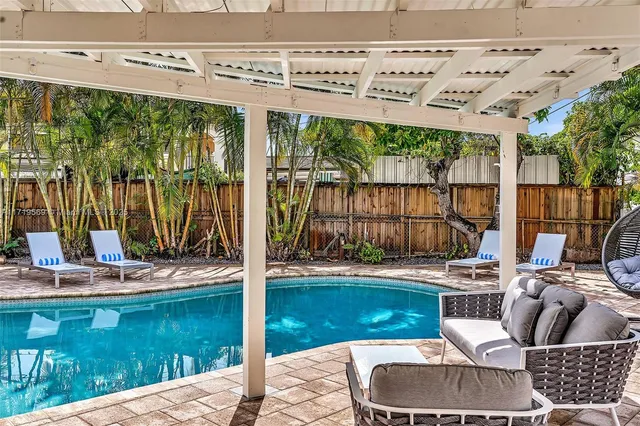 a view of a patio with table and chairs under an umbrella