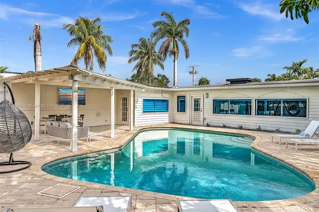 a view of a patio with table and chairs and potted plants