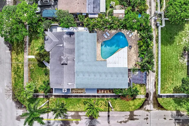 an aerial view of a house with a garden and plants