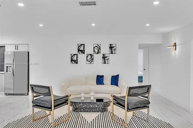 a bedroom with a bed and a table with potted plant