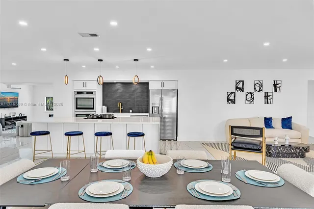 a kitchen with furniture and a dining table