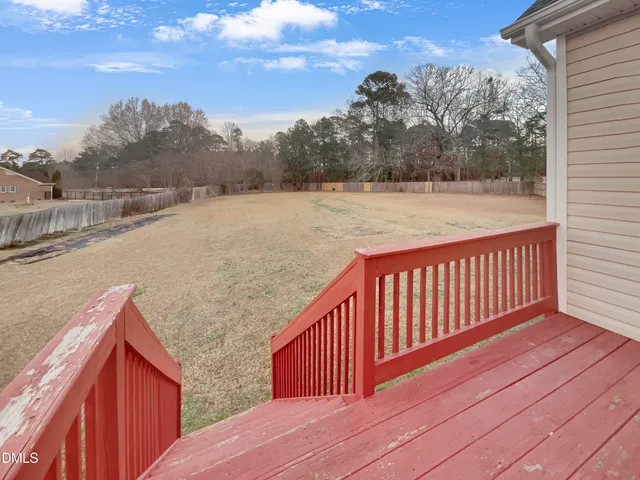 a balcony with wooden floor and city view