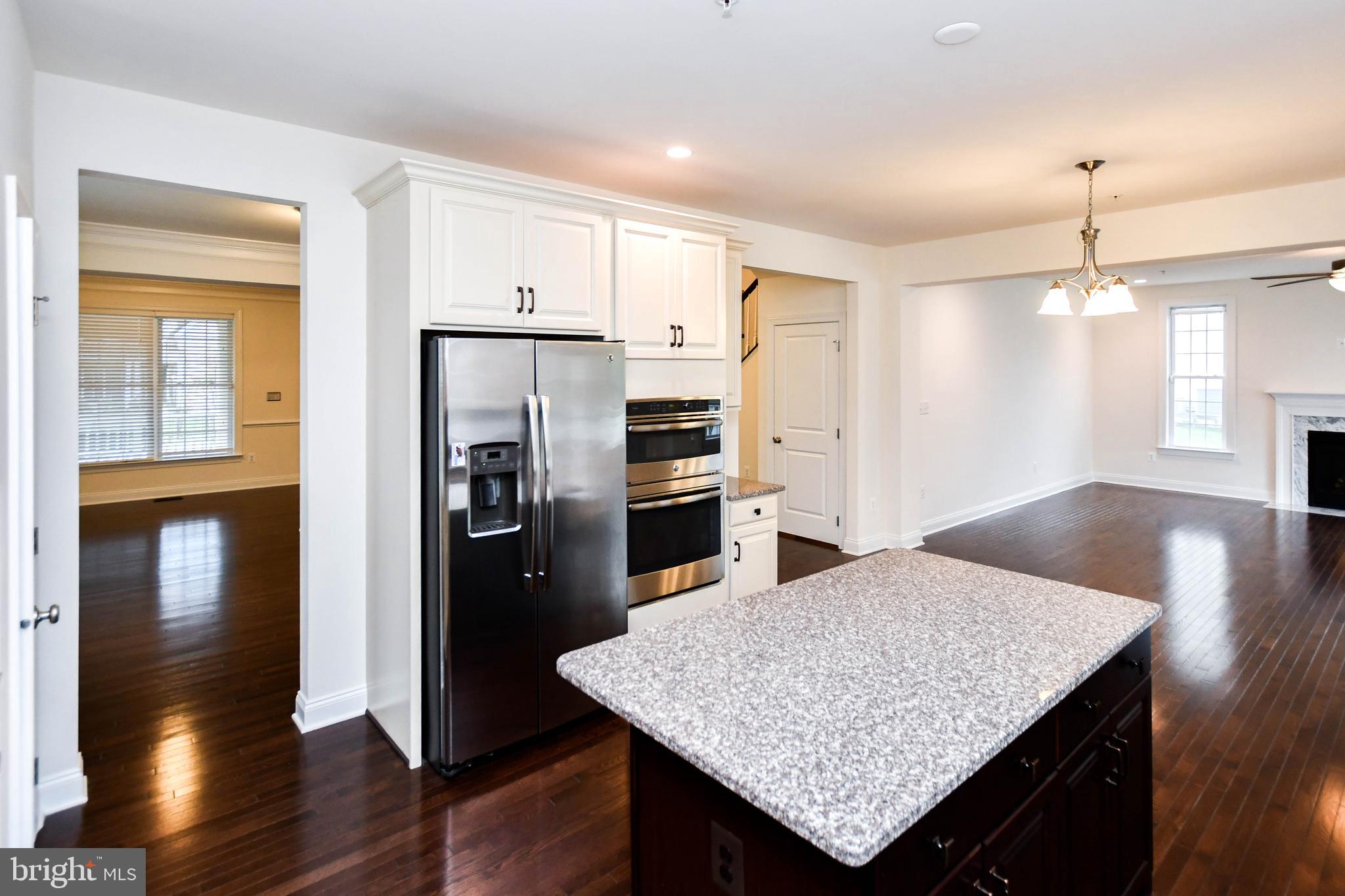 1610 Stream Valley Overlook Severn, MD 21144 - Photo 16 of 86 a kitchen with stainless steel appliances granite countertop a refrigerator a sink and wooden floor