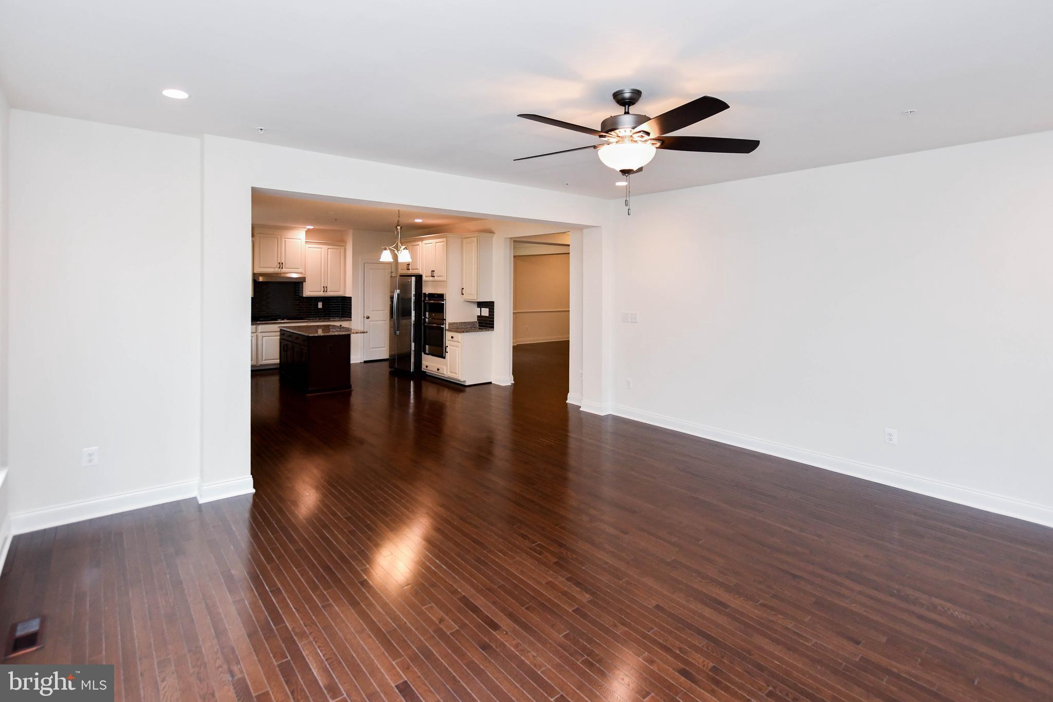 1610 Stream Valley Overlook Severn, MD 21144 - Photo 22 of 86 a view of a livingroom with furniture wooden floor and a ceiling fan