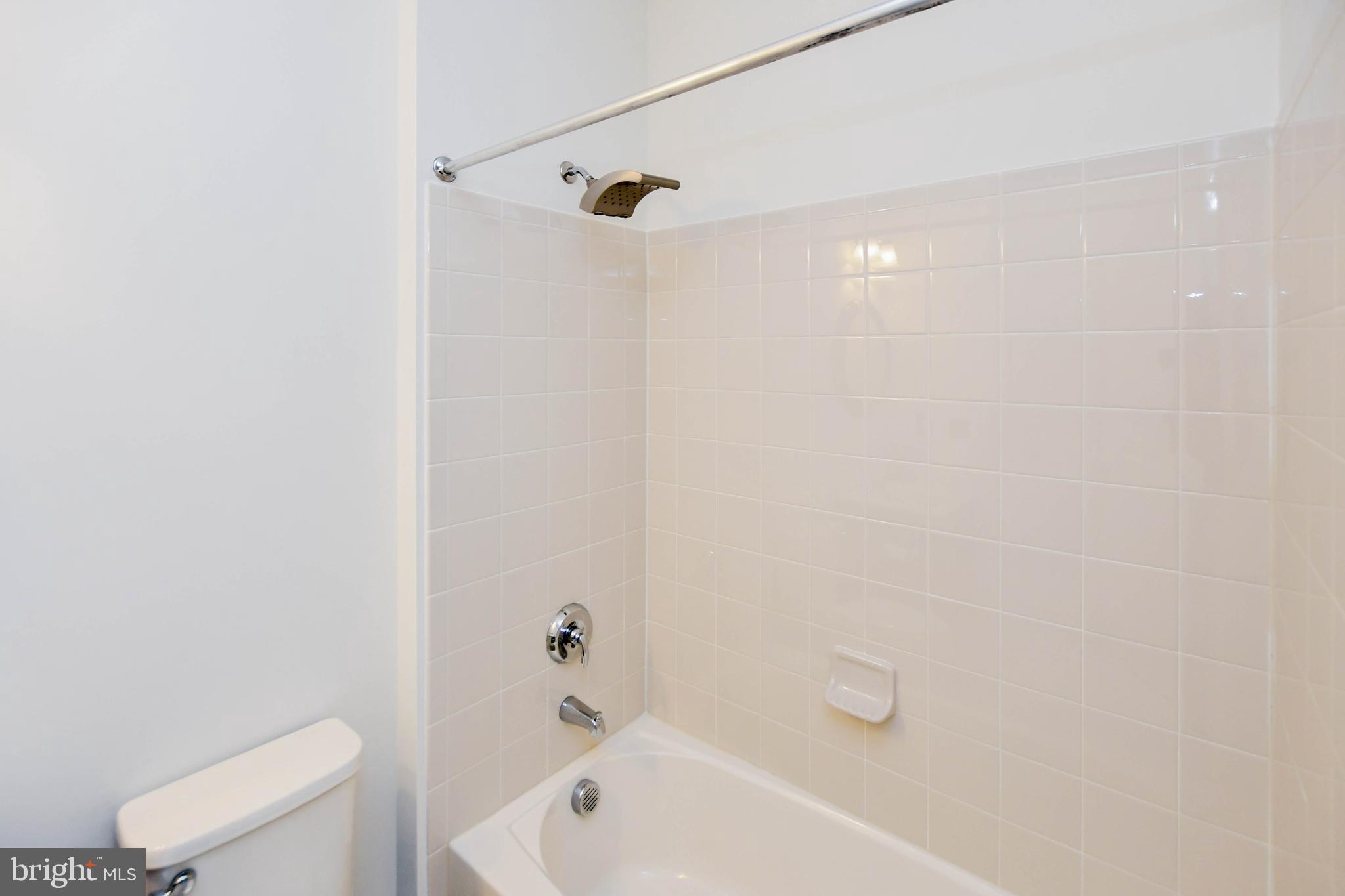 1610 Stream Valley Overlook Severn, MD 21144 - Photo 27 of 86 a bathroom with a bathtub and toilet
