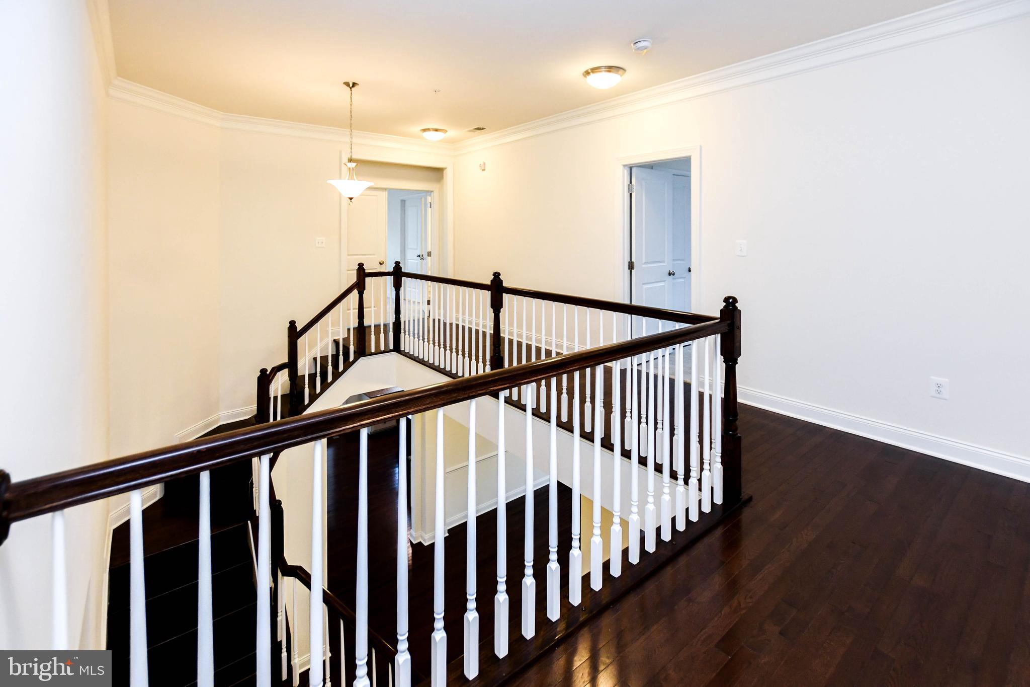 1610 Stream Valley Overlook Severn, MD 21144 - Photo 39 of 86 a view of staircase with railing and a chandelier