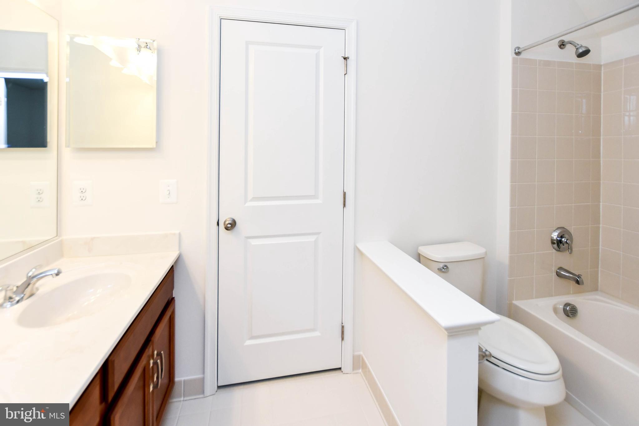 1610 Stream Valley Overlook Severn, MD 21144 - Photo 40 of 86 a bathroom with a sink a toilet and shower