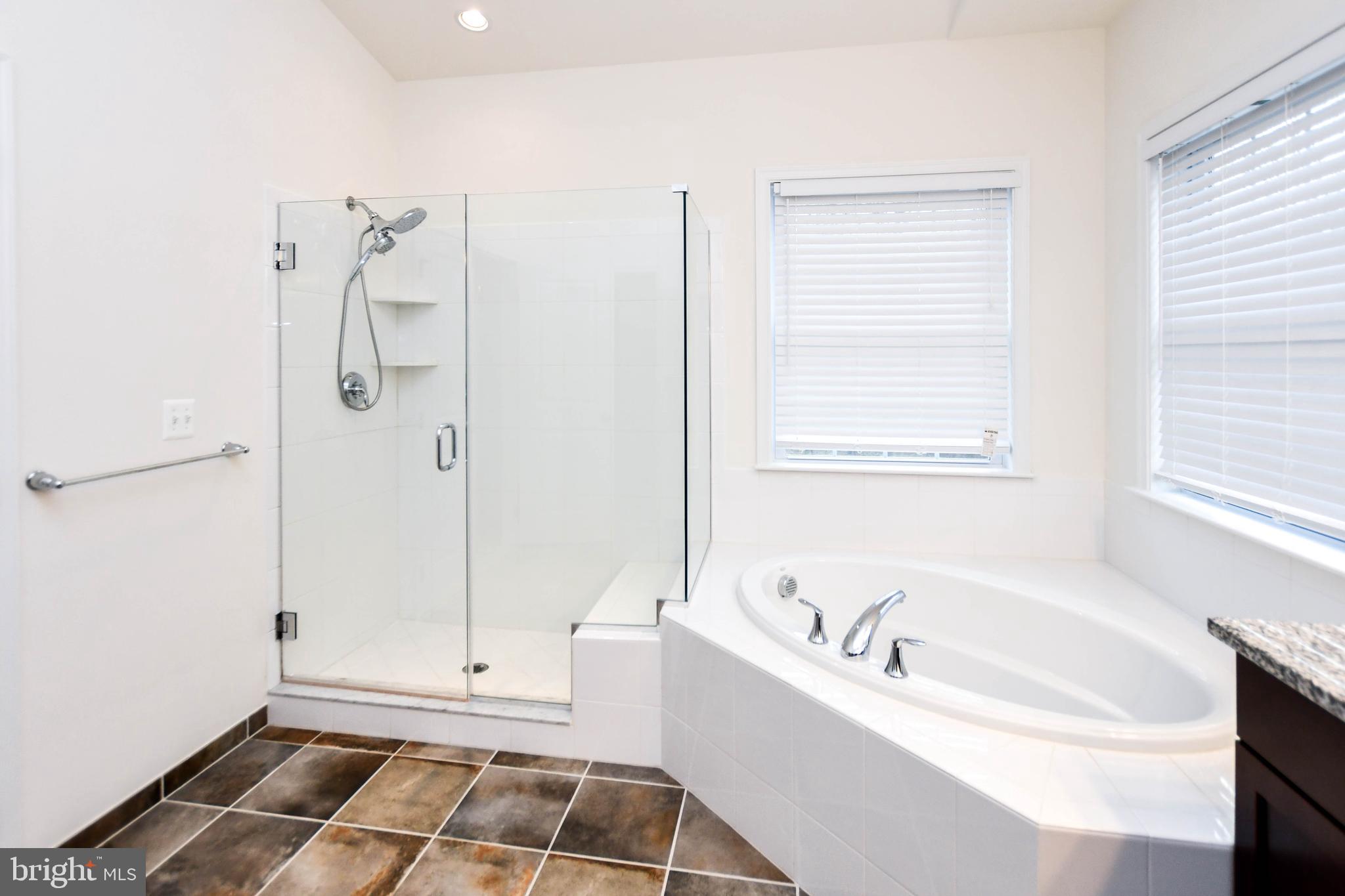 1610 Stream Valley Overlook Severn, MD 21144 - Photo 50 of 86 a bathroom with a bathtub and a shower