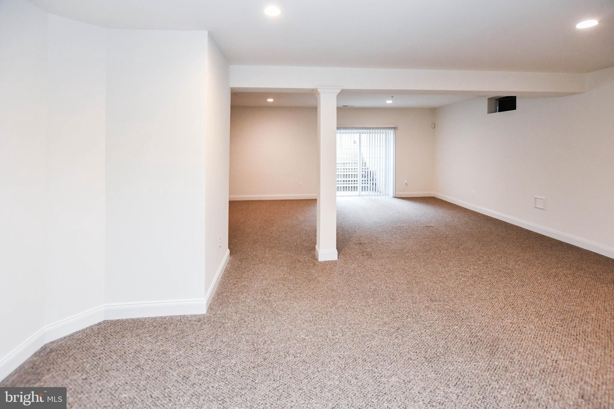 1610 Stream Valley Overlook Severn, MD 21144 - Photo 69 of 86 an empty room with windows and entrance to other room