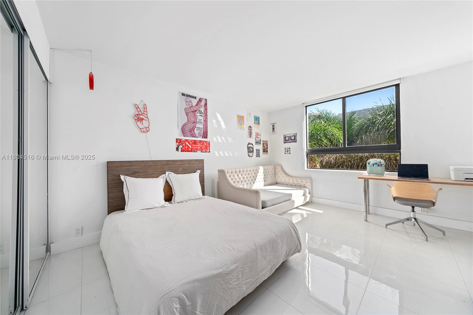 161 Crandon Boulevard, Unit 419 Key Biscayne, FL 33149 - Photo 11 of 35 a bedroom with furniture and a large window