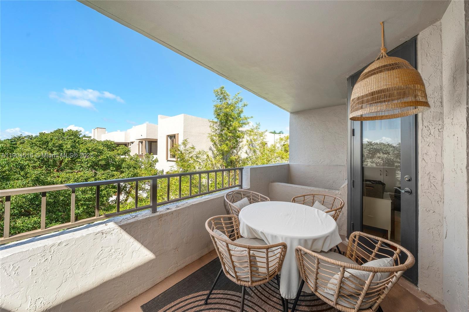 161 Crandon Boulevard, Unit 419 Key Biscayne, FL 33149 - Photo 17 of 35 a balcony with table and chairs