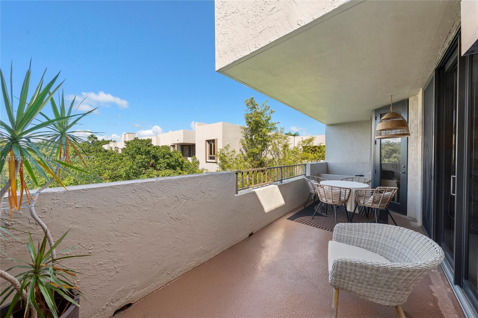161 Crandon Boulevard, Unit 419 Key Biscayne, FL 33149 - Photo 18 of 35 a balcony with couple of couches and potted plants