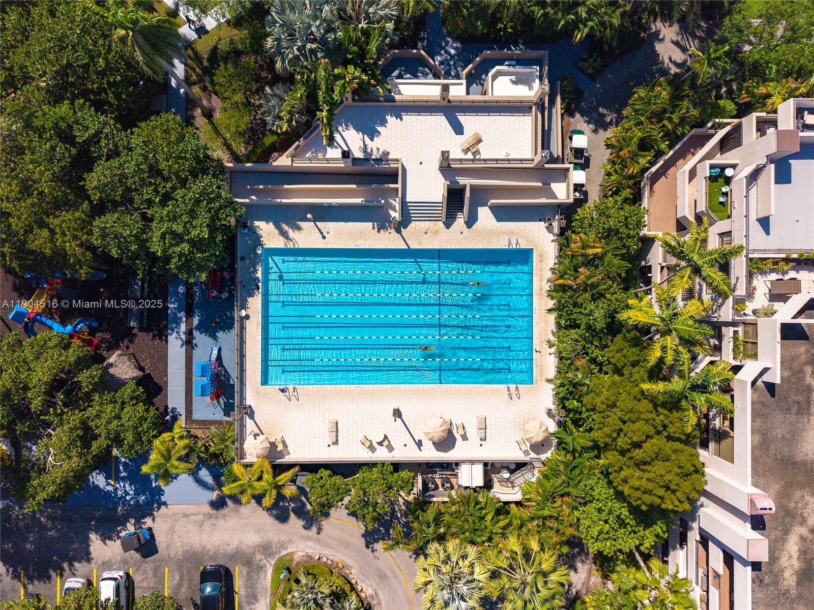 161 Crandon Boulevard, Unit 419 Key Biscayne, FL 33149 - Photo 21 of 35 front view of a house with a bench