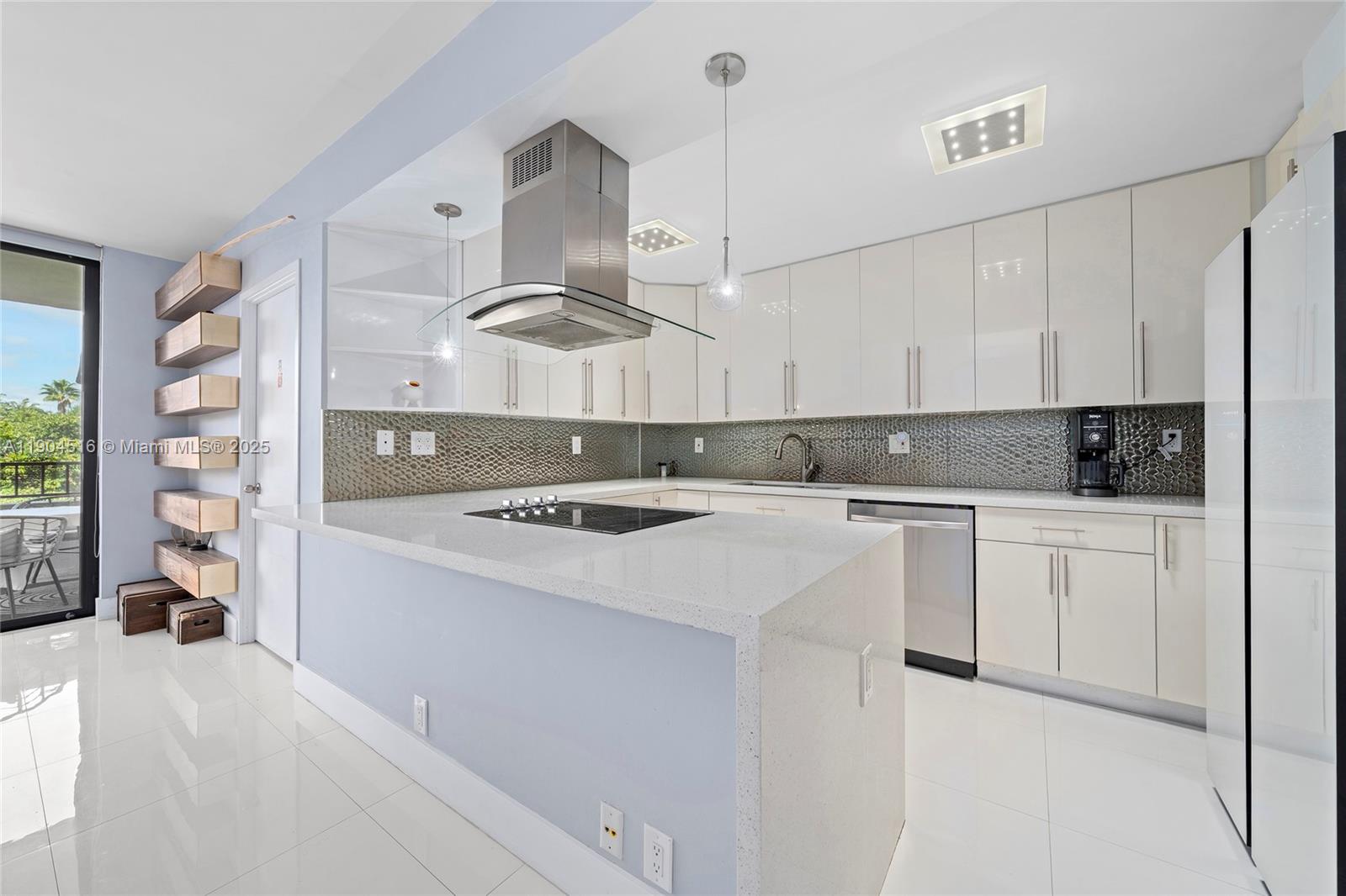 161 Crandon Boulevard, Unit 419 Key Biscayne, FL 33149 - Photo 3 of 35 a kitchen with a stove a sink and a refrigerator