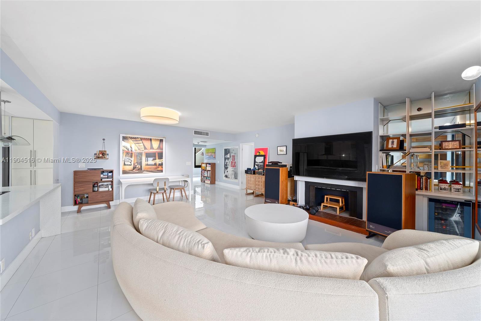 161 Crandon Boulevard, Unit 419 Key Biscayne, FL 33149 - Photo 4 of 35 a living room with furniture a flat screen tv and a fireplace