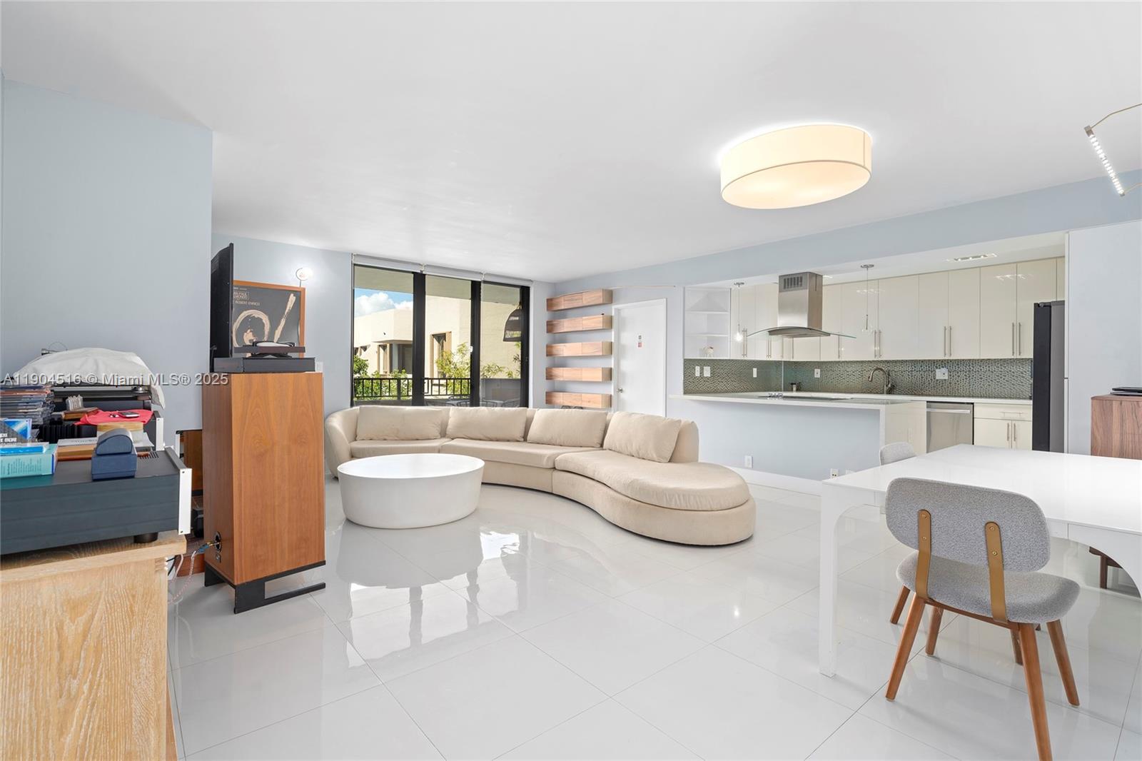 161 Crandon Boulevard, Unit 419 Key Biscayne, FL 33149 - Photo 5 of 35 a living room with furniture and a large window