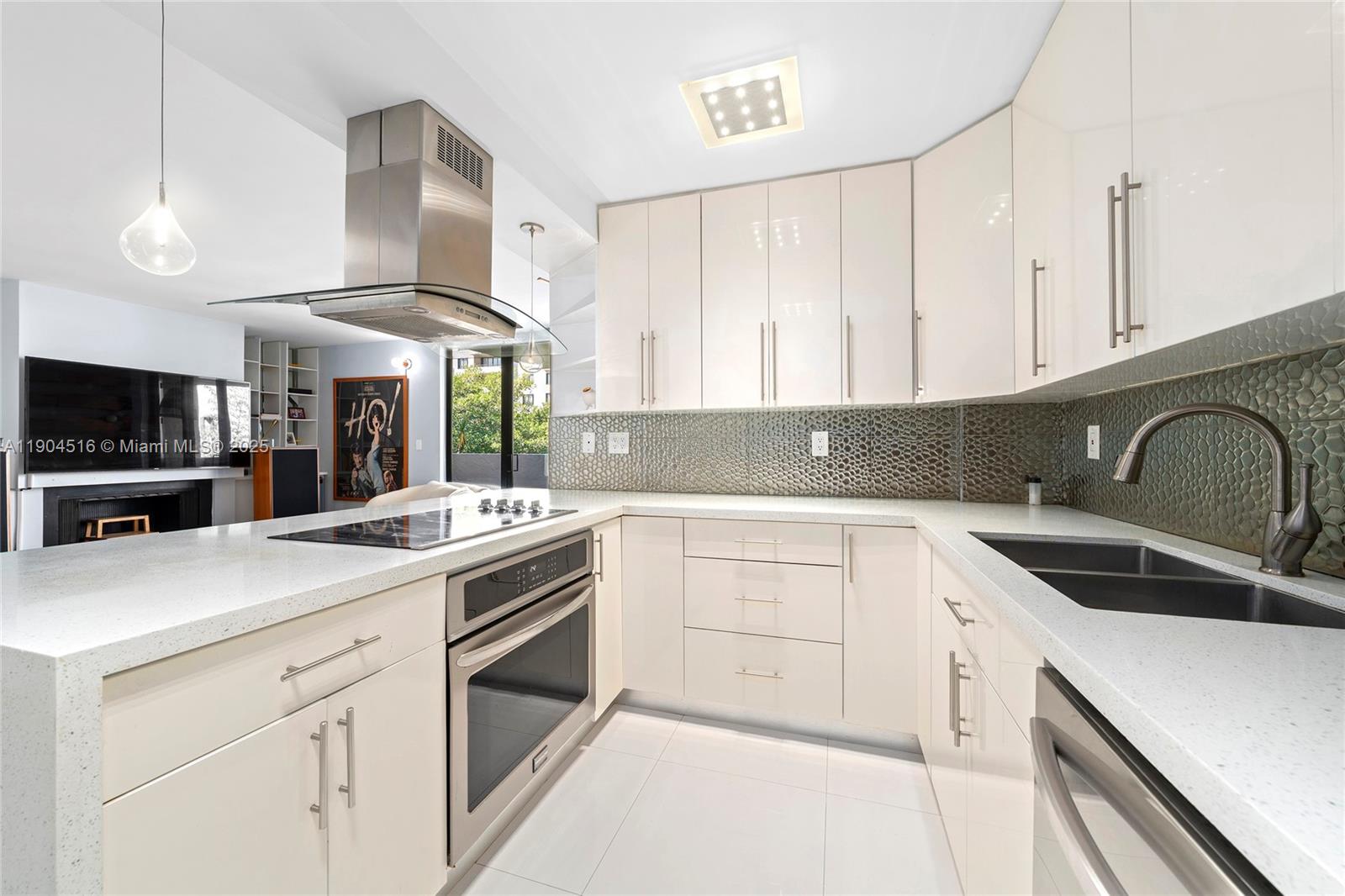 161 Crandon Boulevard, Unit 419 Key Biscayne, FL 33149 - Photo 6 of 35 a kitchen with a sink stove and cabinets