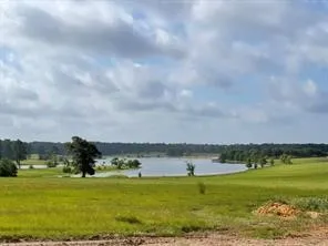 a view of a lake with a big yard