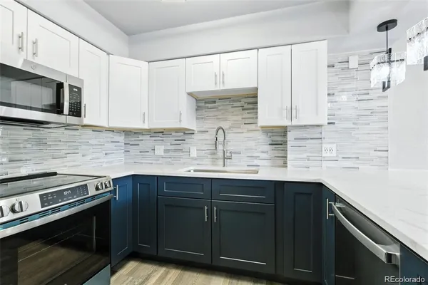 a kitchen with stainless steel appliances a sink stove and cabinets