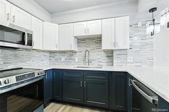 a kitchen with stainless steel appliances a sink stove and cabinets