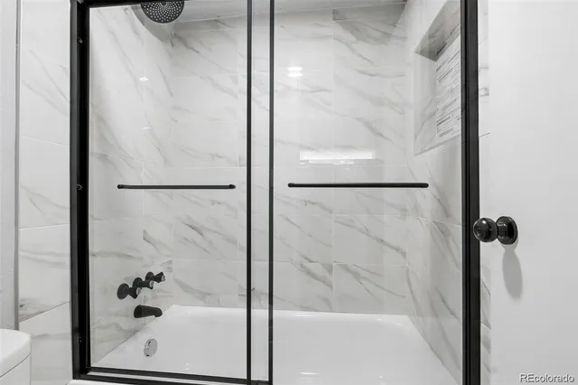 a bathroom with a glass shower door