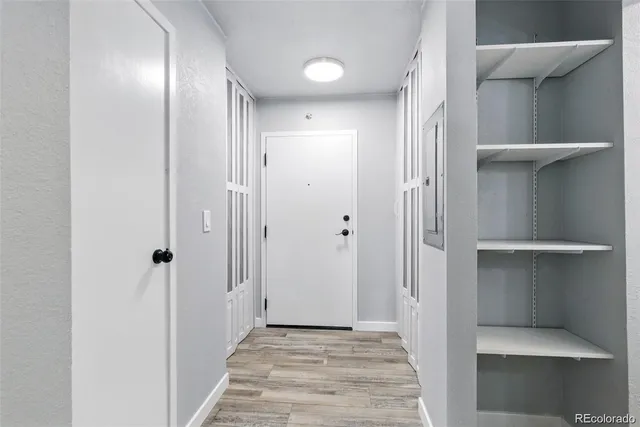 a view of a hallway with wooden floor