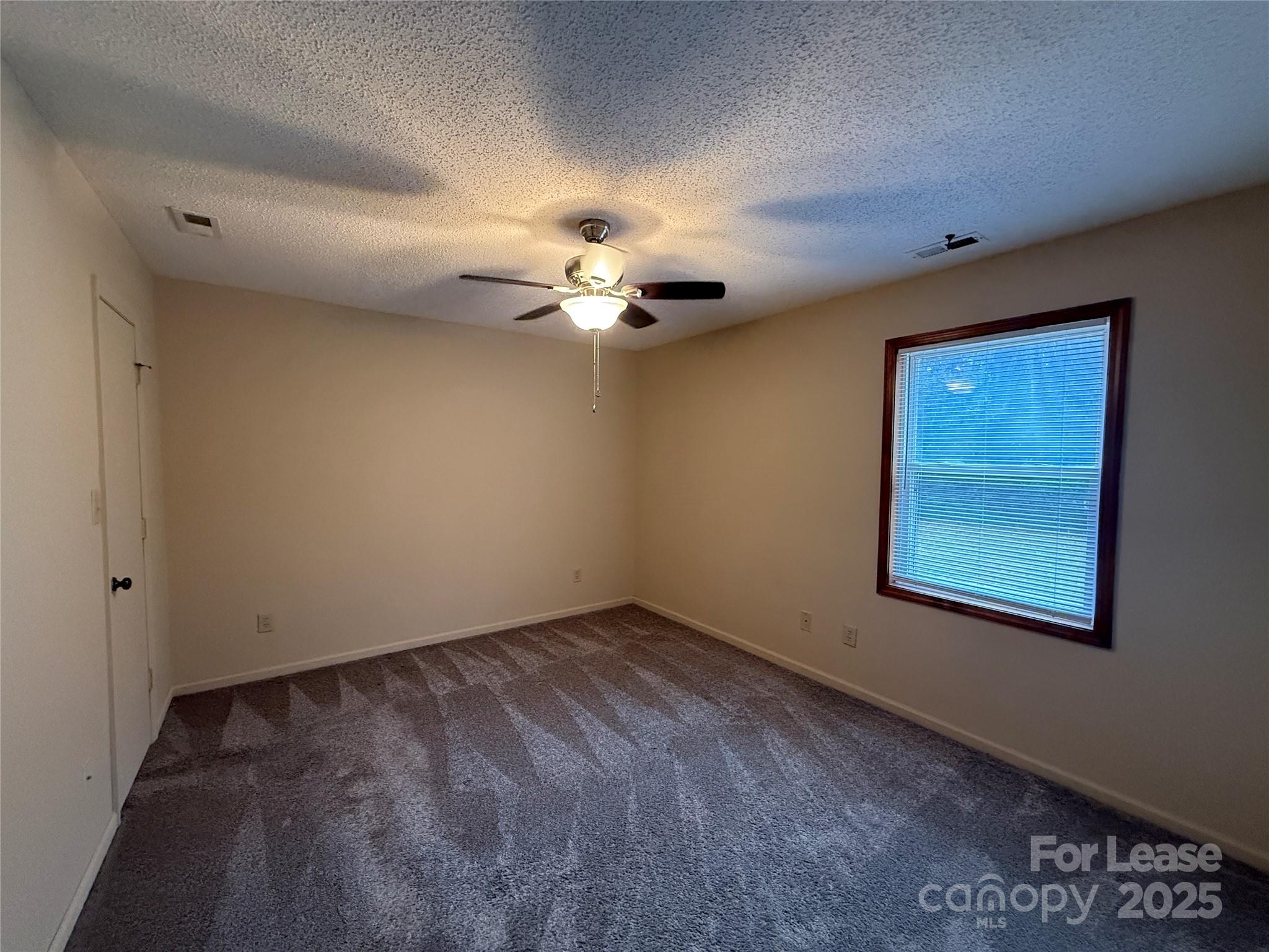 131 Pine Meadow Lane Mooresville, NC 28117 - Photo 16 of 20 a view of a livingroom with a ceiling fan and window