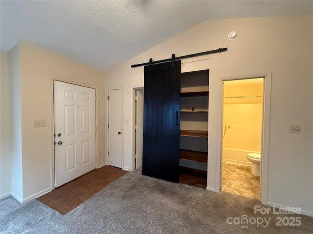 a view of an empty room with a closet