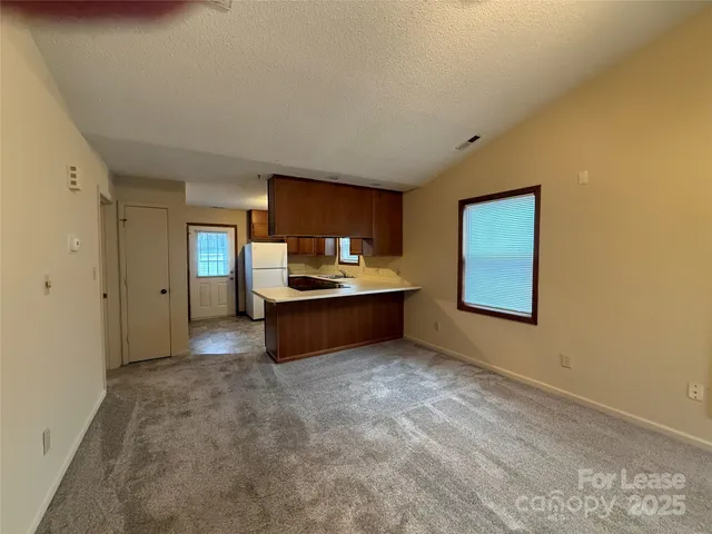 a view of a kitchen with a sink and a refrigerator