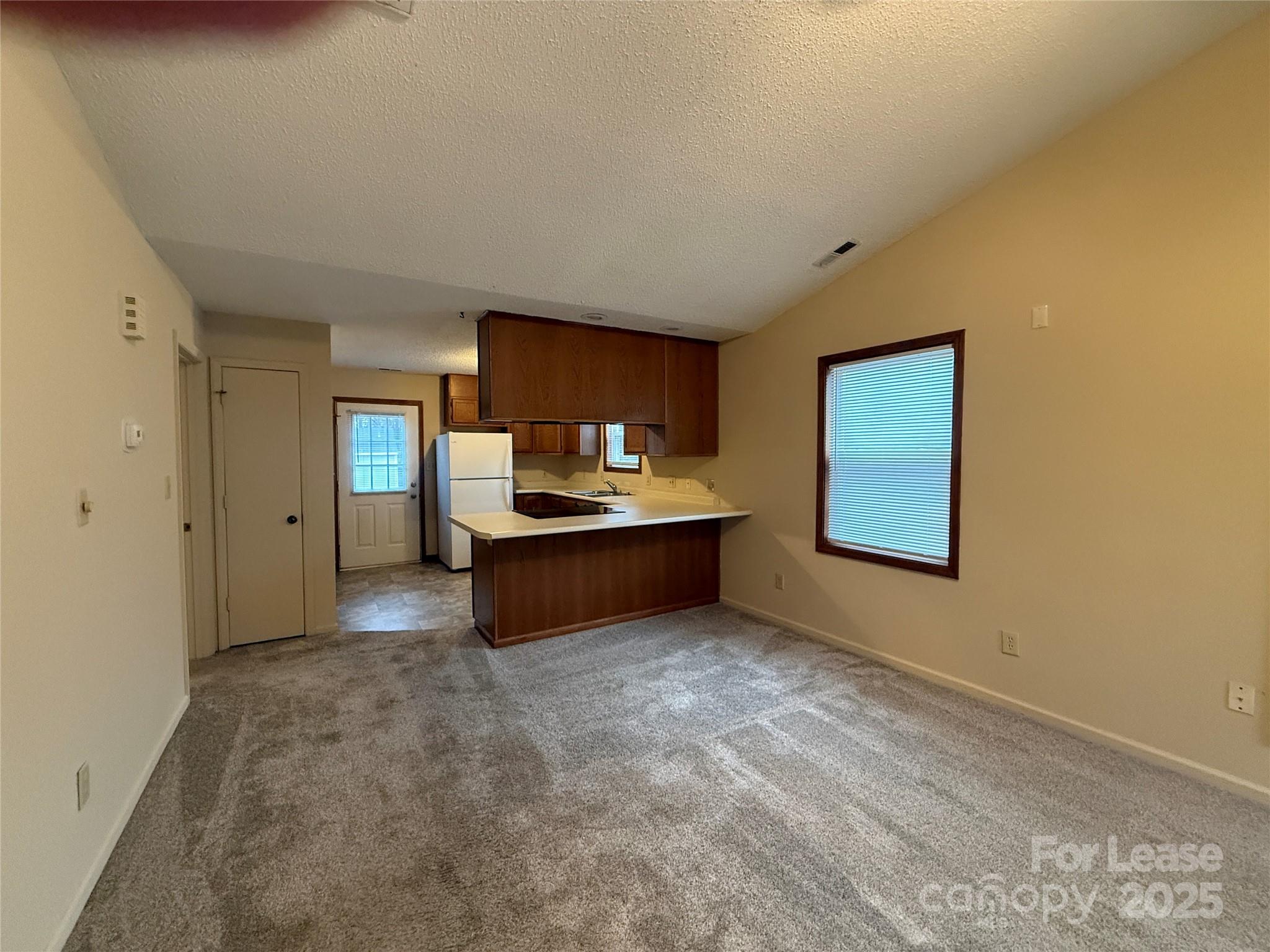 131 Pine Meadow Lane Mooresville, NC 28117 - Photo 5 of 20 a view of a kitchen with a sink and a refrigerator