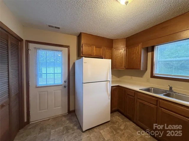 a white refrigerator freezer sitting inside of a kitchen