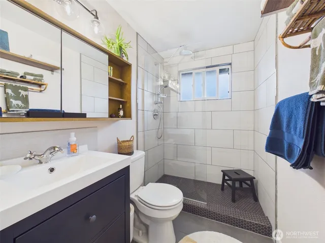 a bathroom with a sink mirror vanity and toilet