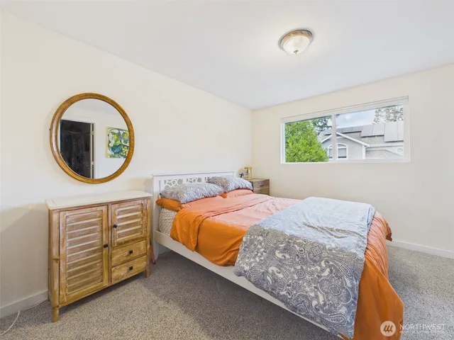 a bedroom with a bed and a couch