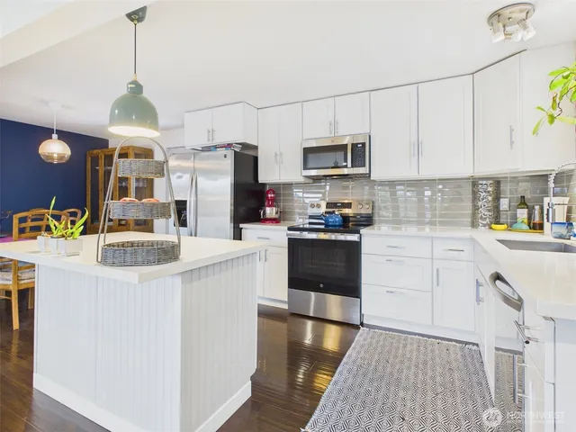 a open kitchen with cabinets a sink and a stove